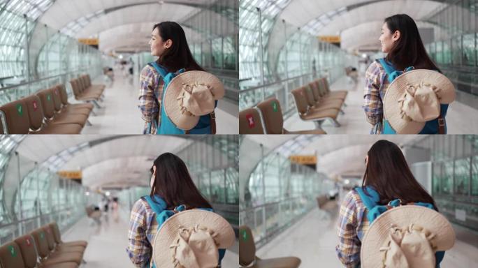 亚洲旅游妇女走过机场航站楼在机场旅行，慢动作
