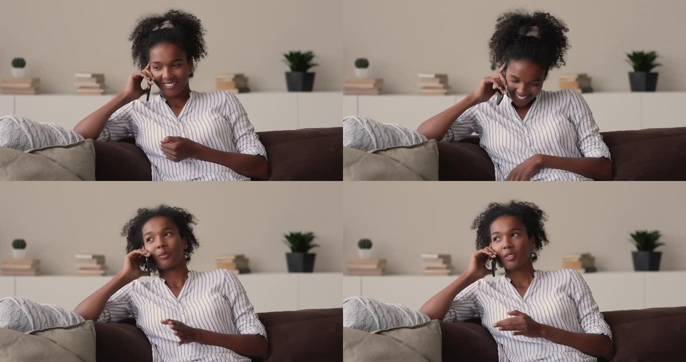 快乐的年轻非洲裔美国妇女拿着手机通话。