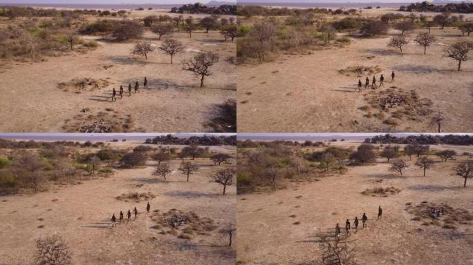 空中。由于气候变化，哈扎 (Hadza) 狩猎采集者部落成员在干旱的景观中用弓箭狩猎。坦桑尼亚