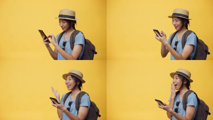 快乐青春美丽的亚洲女人戴帽子背包拿着智能手机享受预订旅行酒店和机票预订。