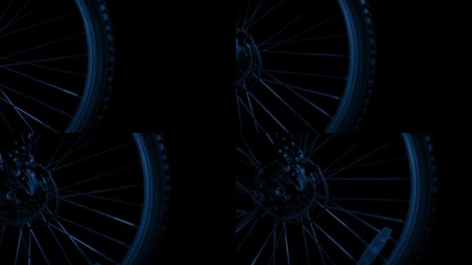 自行车车轮特写镜头，夜间闪烁的车灯