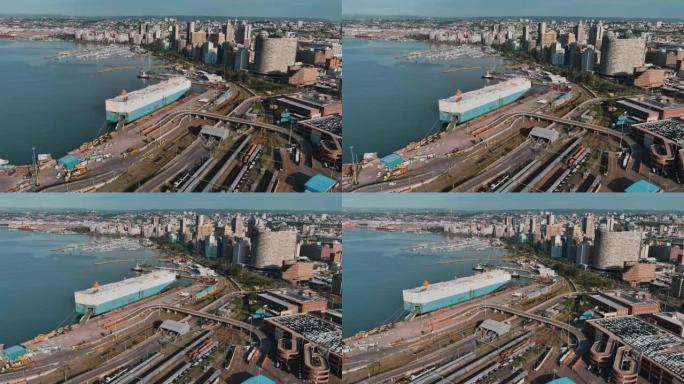 背景中停靠在德班市中心德班港的自动船的空中平移视图