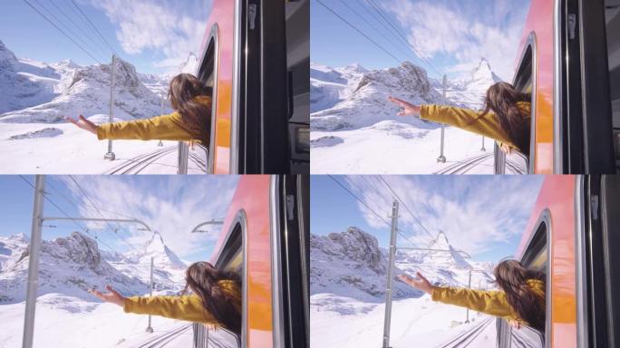 女性坐在火车上的兴奋，同时将手臂从窗外举起，乘火车旅行到欧洲瑞士采尔马特的马特宏山。具有多样性概念的