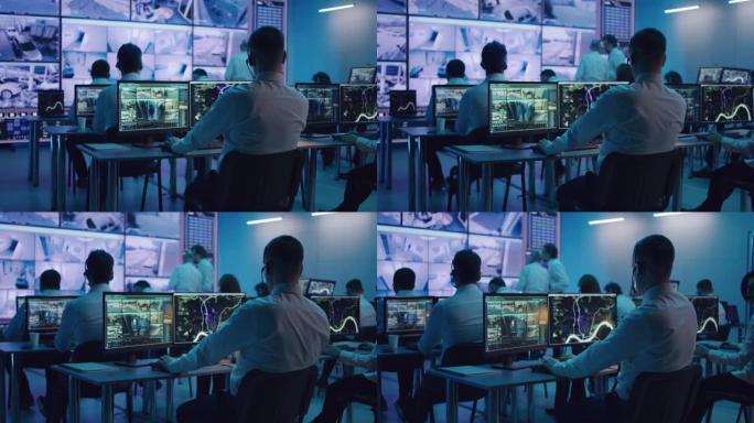 男性间谍在电脑上浏览视频和地图