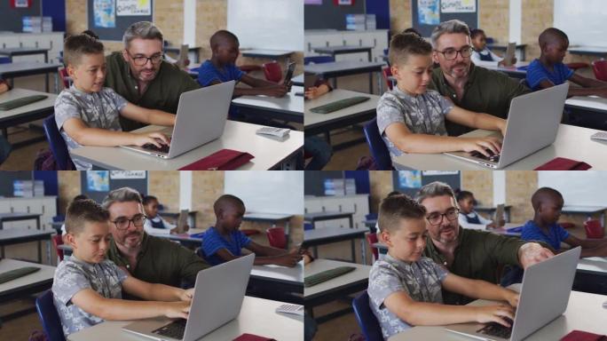 多元化的男老师使用笔记本电脑帮助坐在教室里的男生