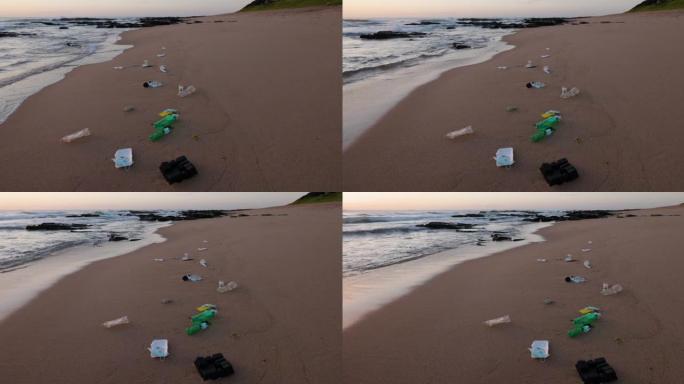 塑料污染。冠状病毒新型冠状病毒肺炎防护口罩洗刷并污染海滩以及塑料瓶和塑料垃圾