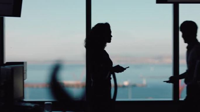 剪影商务女性使用智能手机走过办公室发短信发送信息成功的女性高管检查到达工作场所的手机电子邮件