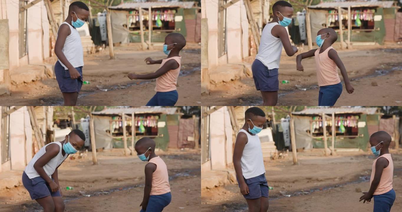 非洲黑人男孩用新的手肘来迎接Covid-19替代握手。新标准的概念