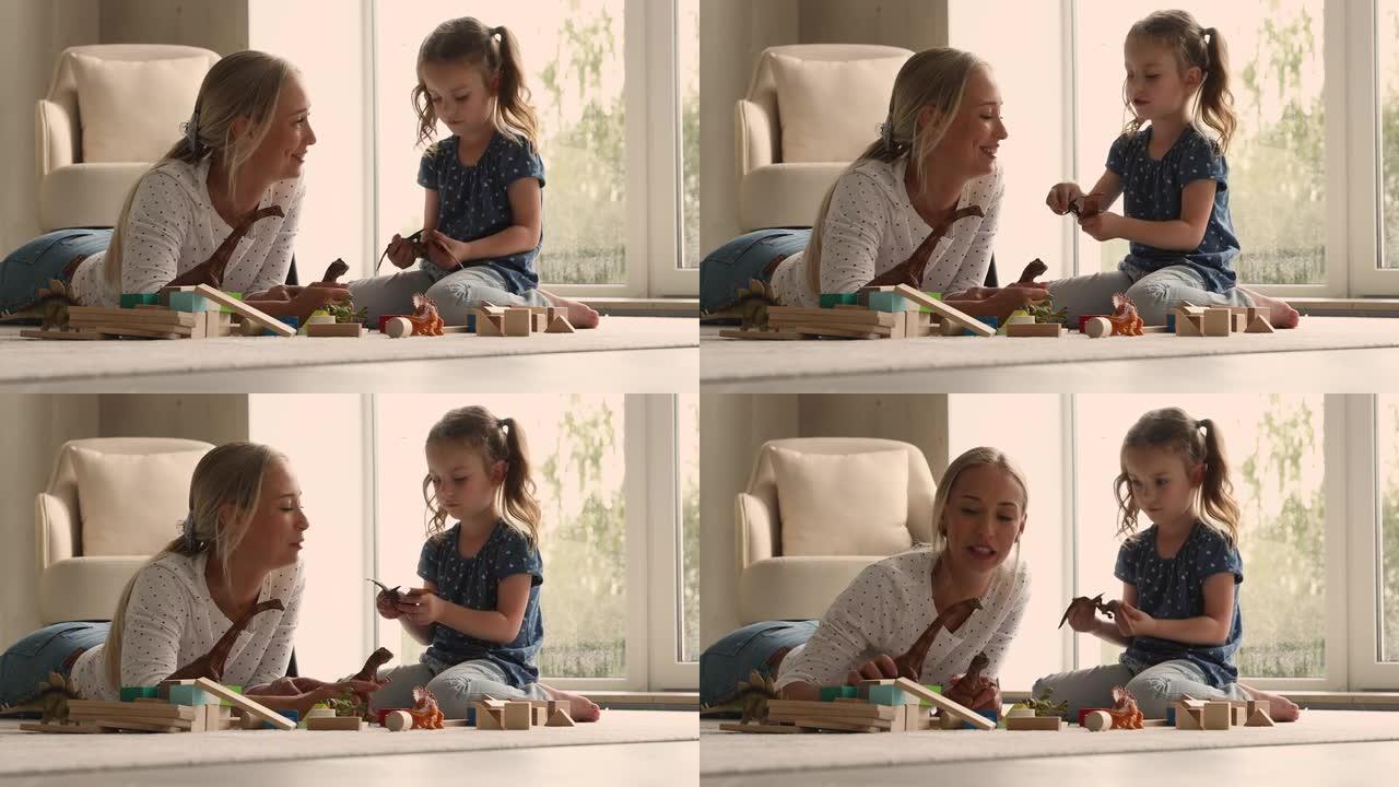 年轻女子玩恐龙玩具套装与小可爱女儿