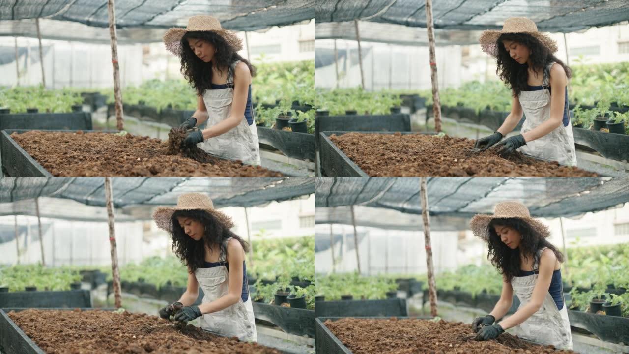 亚洲女人在家快乐地在花园里工作