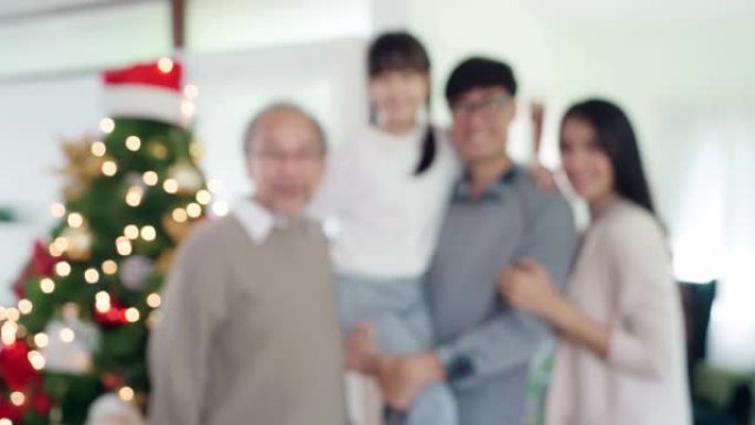 4K UHD手持换挡焦点肖像微笑多代亚洲幸福家庭站在一起，装饰完装饰品。