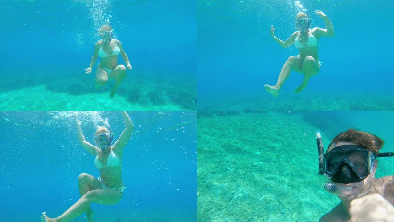 女士穿着比基尼的年轻女子与男友在水下浮潜，克罗地亚亚得里亚海