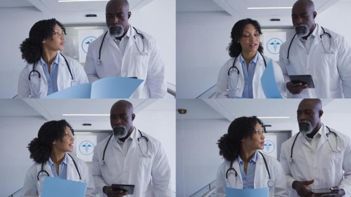 非裔美国男性和女性高级医生在医院讨论医疗报告