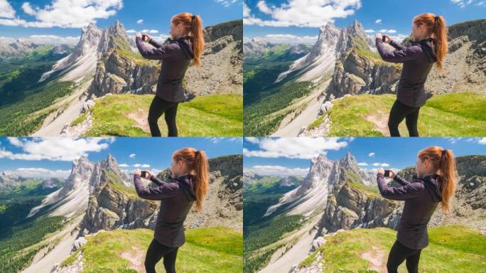 山顶上的女徒步旅行者用智能手机拍摄令人叹为观止的景色