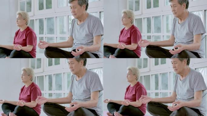 亚洲老年夫妇做瑜伽冥想家庭锻炼。家庭，生活方式，人，老年人，关系，退休，健康护理，领导，老年人在体育