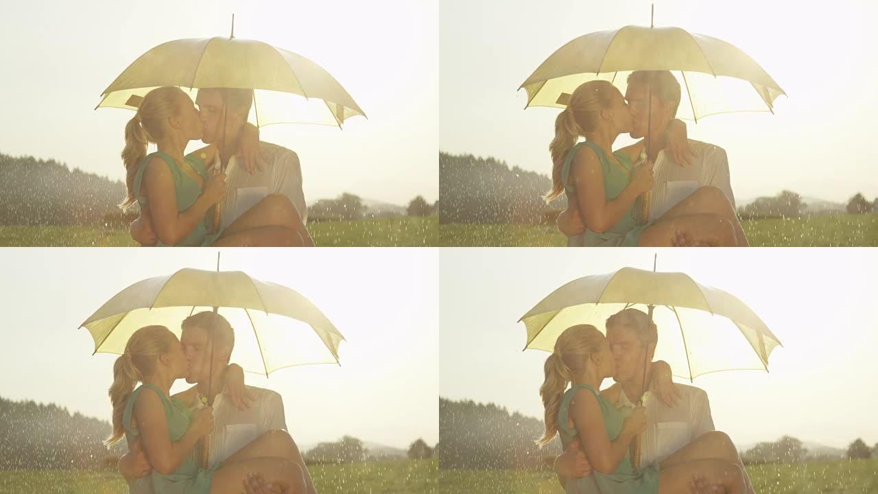 慢动作: 年轻的高加索夫妇在金色的草地上热情地亲吻。