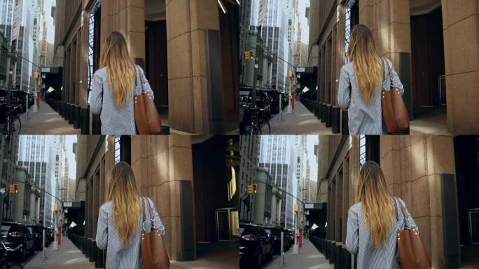 年轻的女商人走过美国纽约金融区到办公室的后景。慢动作