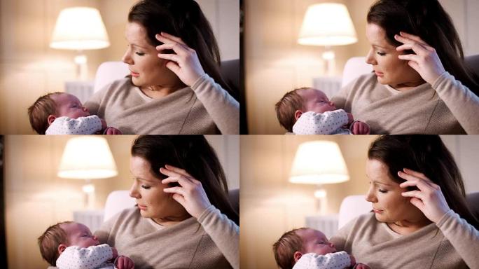 焦虑的新妈妈患有产后抑郁症，在家中抱着熟睡的女婴