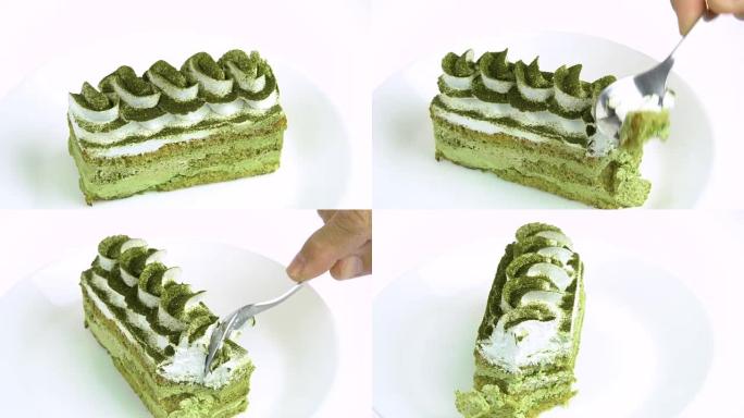 在白色背景上吃绿茶蛋糕。