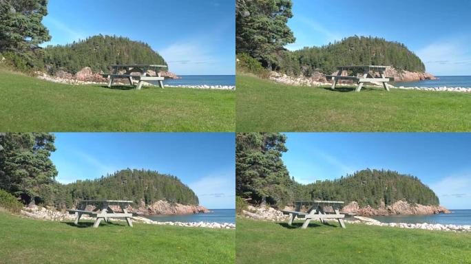 特写: 俯瞰北海和岩石海岸的孤独木凳和桌子