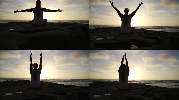 慢动作自由快乐的女人在日落时做成功瑜伽姿势