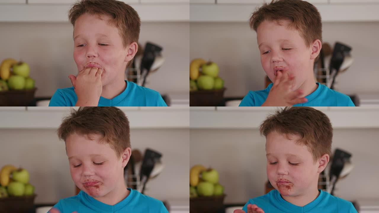 4k小男孩舔手指上的巧克力蛋糕混合物