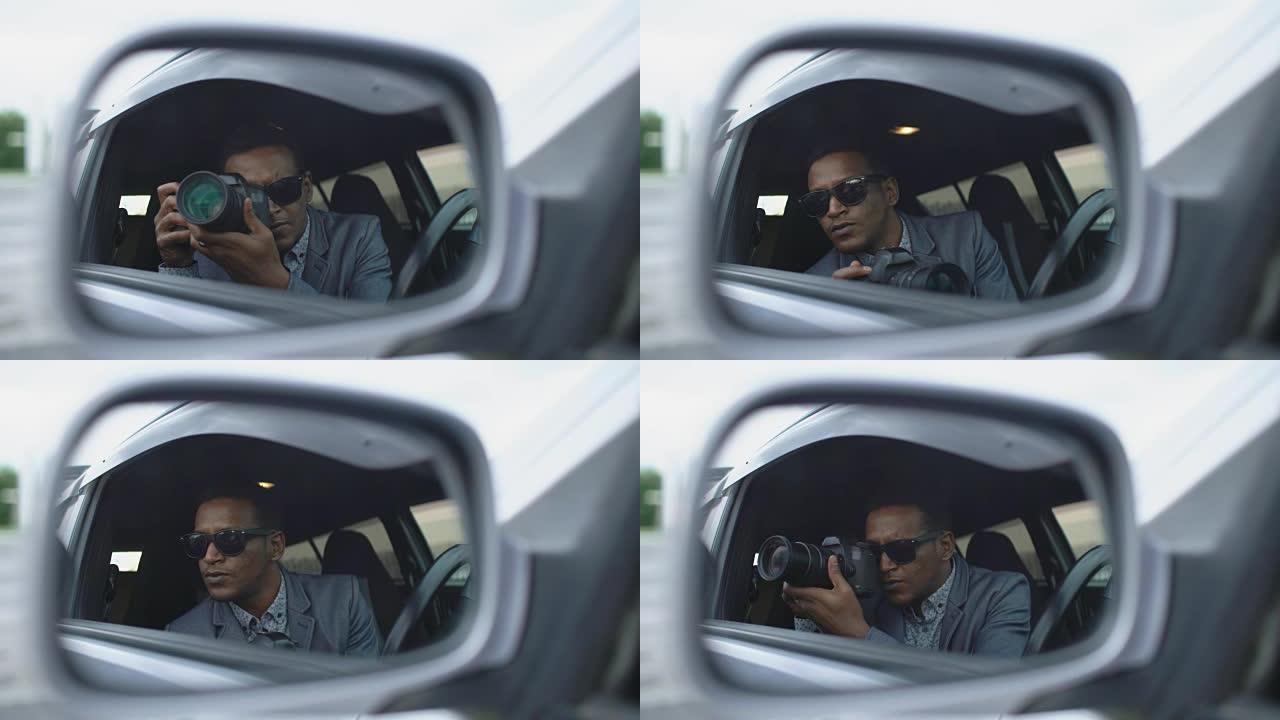 狗仔队男子坐在车里用单反相机拍照的侧镜反射