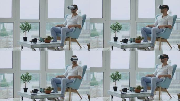 年轻人有使用虚拟现实耳机观看电影的VR体验坐在阳台的椅子上