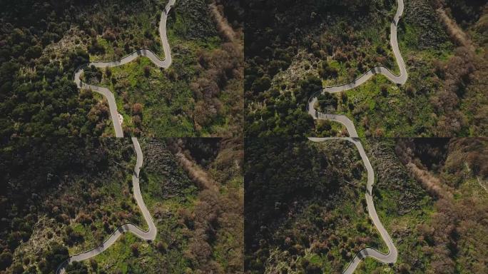 无人机在美丽的山路上右转。夏季蛇形空车道的空中俯视图。4k背景拍摄