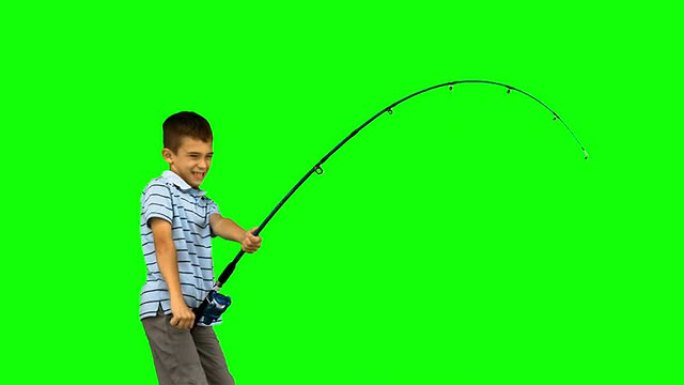 小男孩在绿色屏幕上钓鱼