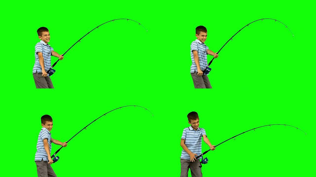 小男孩在绿色屏幕上钓鱼