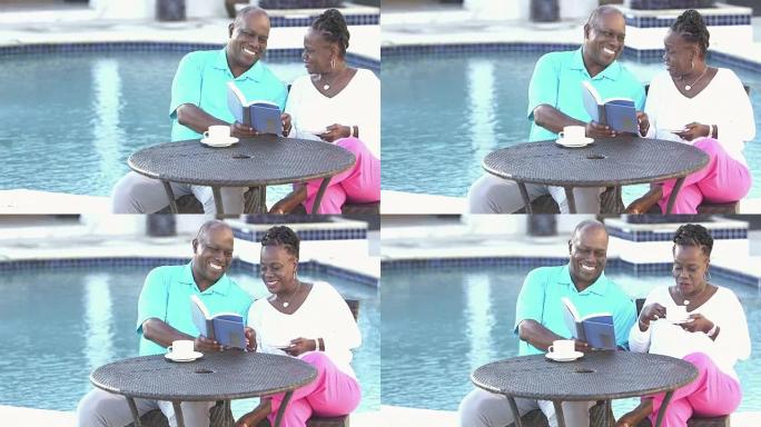 老年非裔美国夫妇在游泳池旁放松