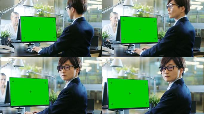 在办公室里，东亚商人在一台带有模拟绿屏的台式个人计算机上工作。他戏剧性地转过头，看着肩膀对着镜头。同