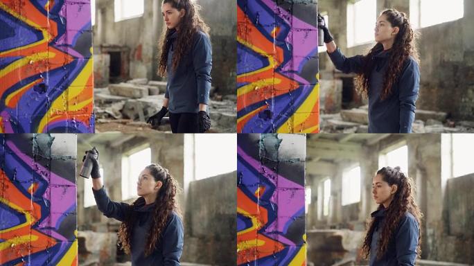 严肃的年轻女性涂鸦艺术家正在使用喷漆在旧仓库的柱子上绘画。背景是废弃的肮脏建筑，地板上有垃圾。