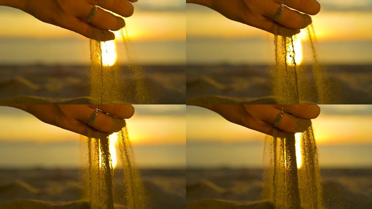 慢动作，反转: 日出时，粗粒沙粒从雌性手中掉落。