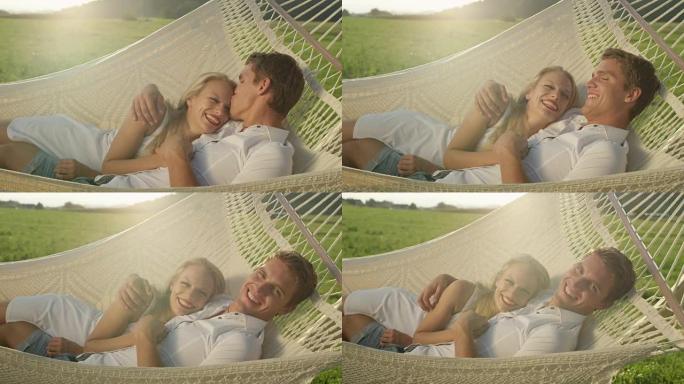 肖像: 快乐的男人躺在浪漫的吊带中亲吻额头上的女友