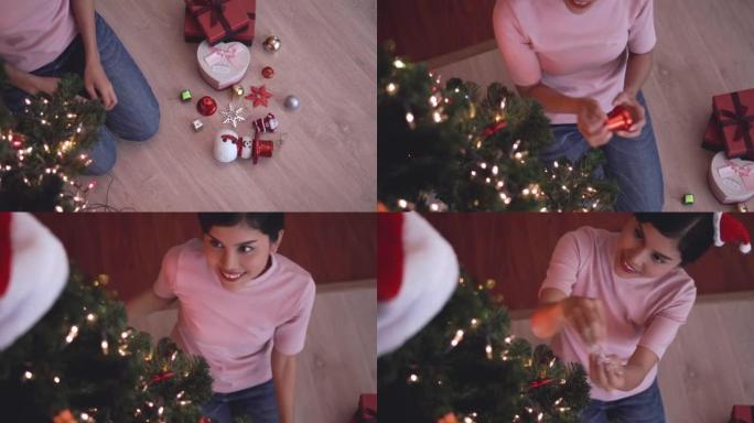 女人装饰圣诞树，家庭视频，相机顶视图。