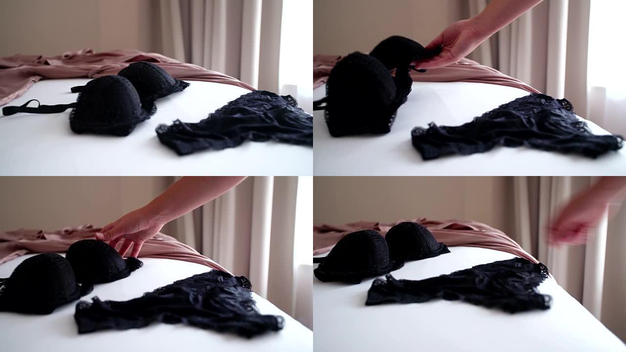 床上黑色性感内衣，浴袍旁边