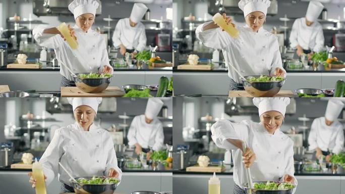 在一家著名的餐馆，女厨师准备沙拉，广告油。她在一个现代化的大厨房里工作。