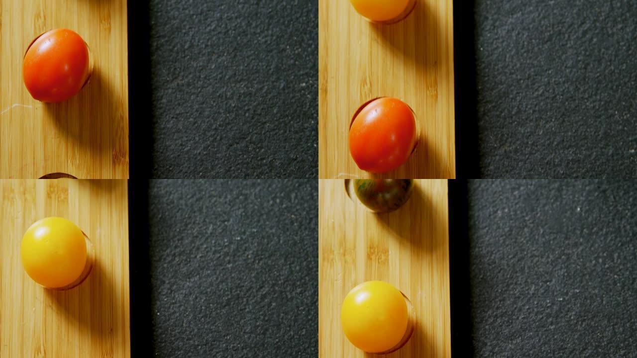 各种西红柿排列在灰色背景4K 4k的木托盘中