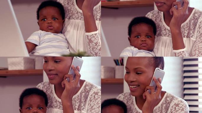 女人在电话里抱着婴儿
