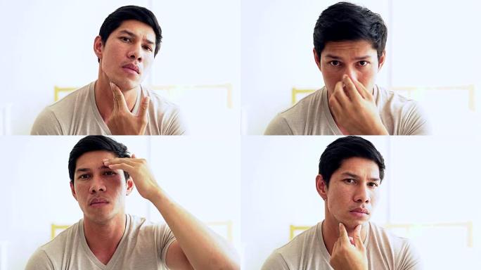年轻的亚洲帅哥映在镜子里，检查他的胡须。