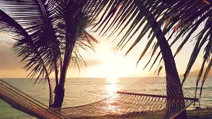 日落时的吊床和棕榈树。Instagram色调。