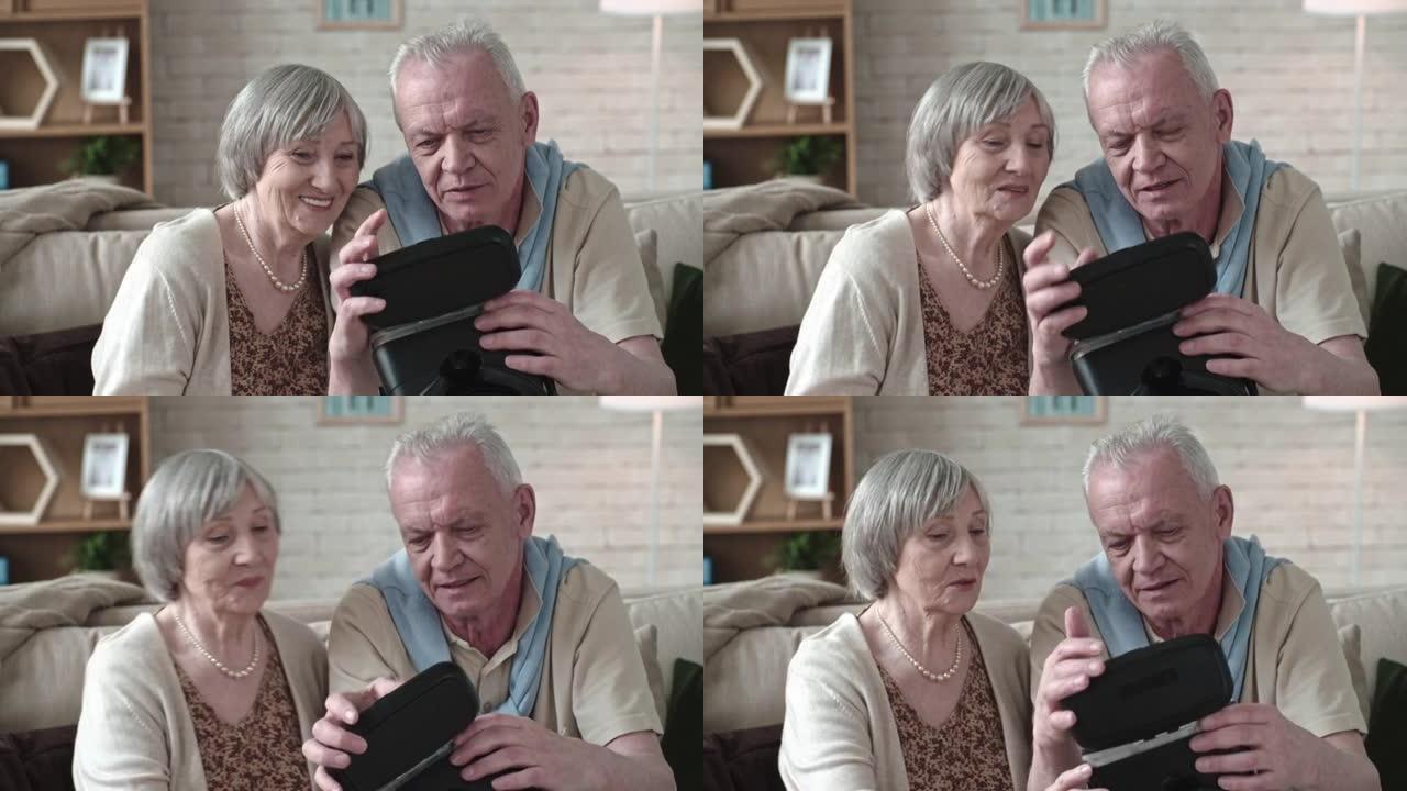 好奇的老年夫妇看着VR护目镜