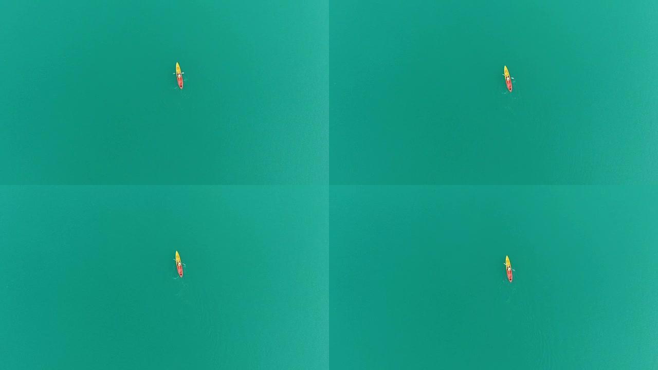 4k鸟瞰图和独自一人在湖中划独木舟的平躺。