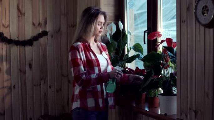 女人用喷枪浇花