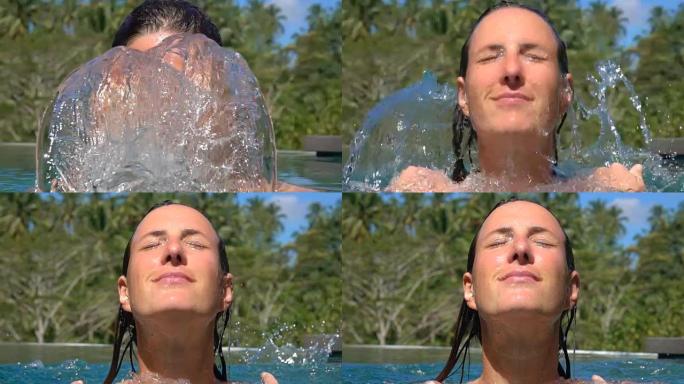 慢动作: 暑假放松的漂亮女性在脸上泼水