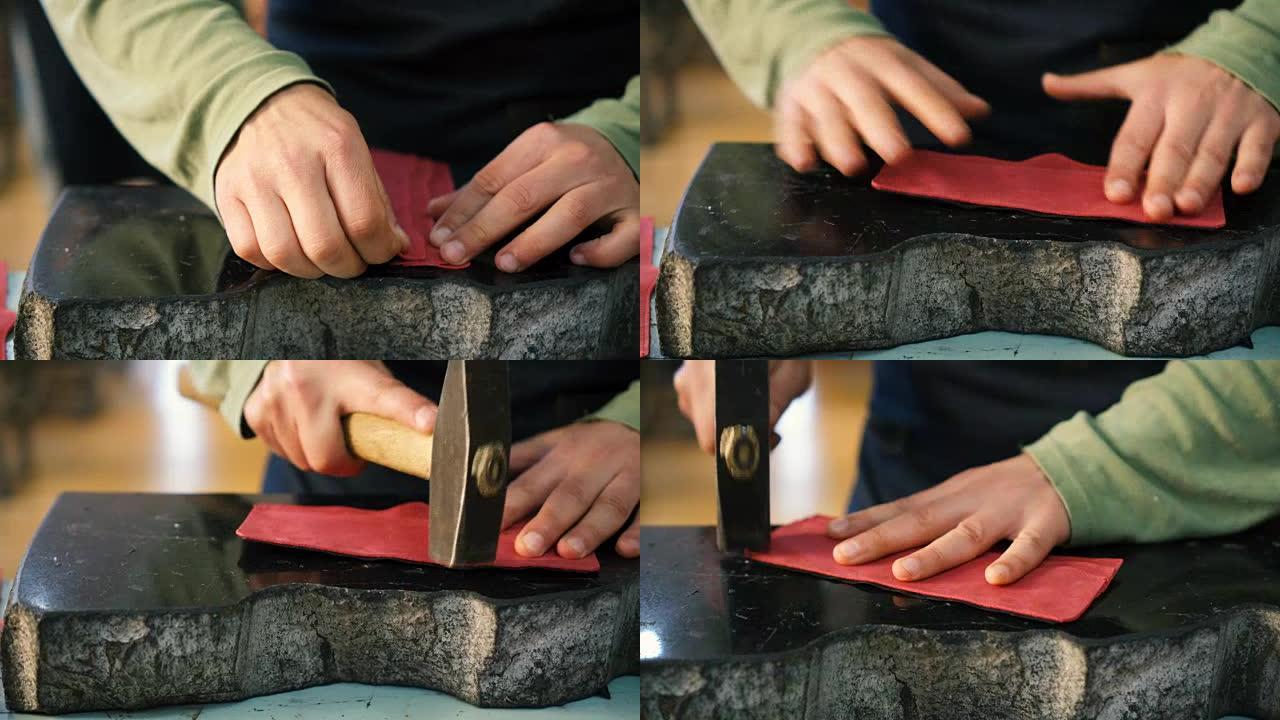 工匠用锤子连接皮革边缘