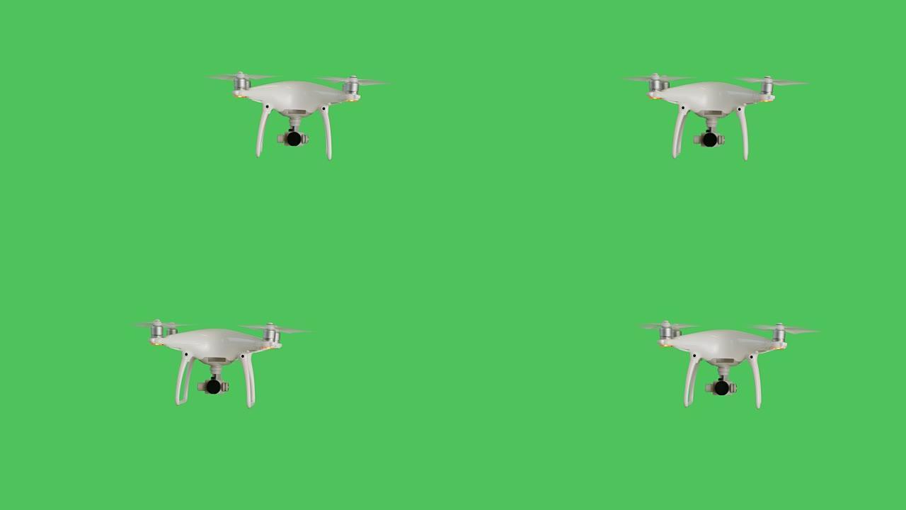 无人机带着相机飞行。背景是绿色屏幕。