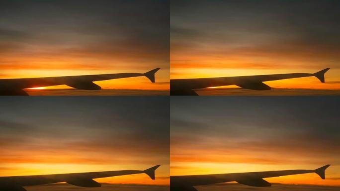 垂直: 飞向华丽的日出时望着飞机的窗户
